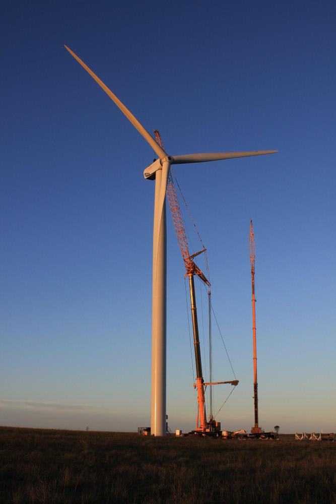 Turbine blade being lifted into place by crane
